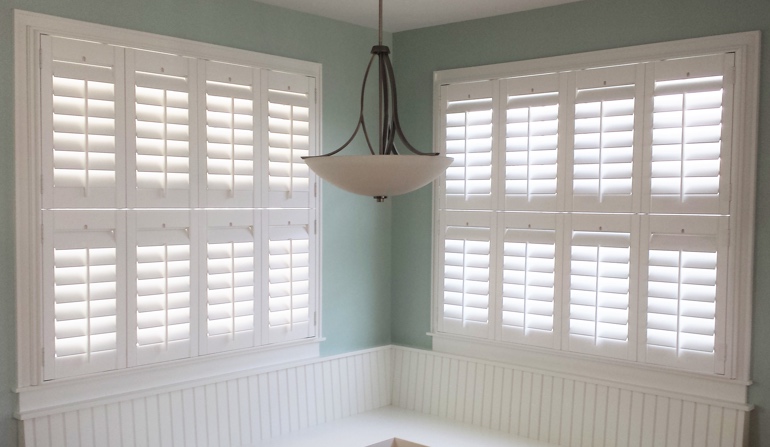 Pastel green wall in Cleveland kitchen with shutters.